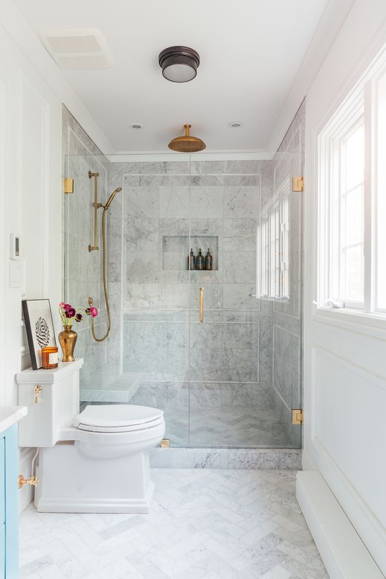 Neutral Bathroom with Marble and Blue Vanity