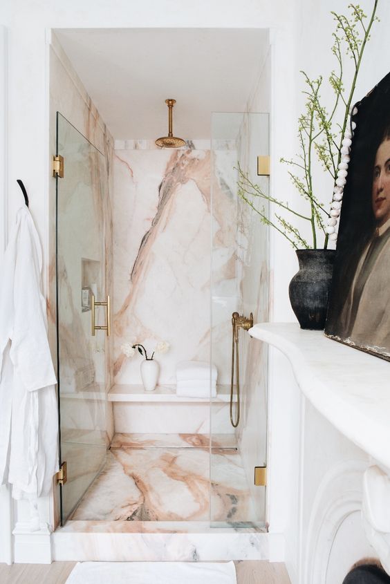 Chic Neutral Bathroom with Pink Stone and Brass Accents