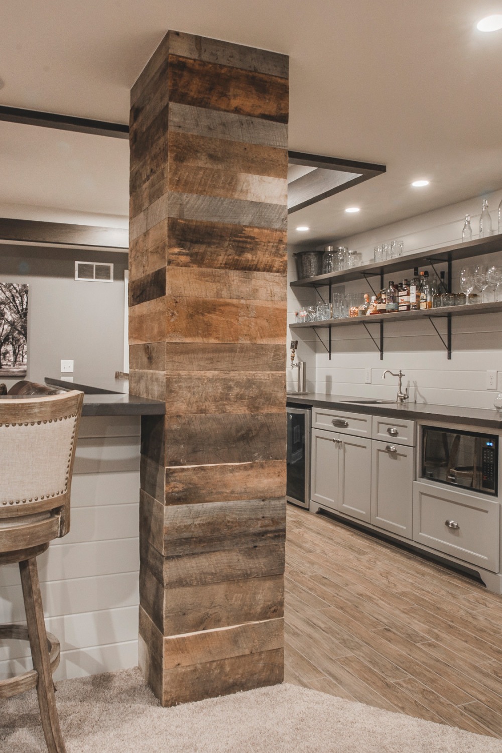 Basement Bar with Contemporary Dual-Toned Cabinetry and Polished Countertops