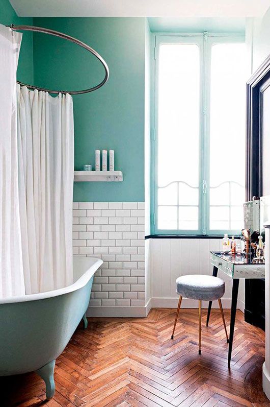 Cozy and Playful Bathroom with Aqua Bathtub and Walls