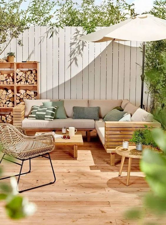 Modern Deck With Wooden Sectional Sofa, Rattan Chair, and Coffee Table