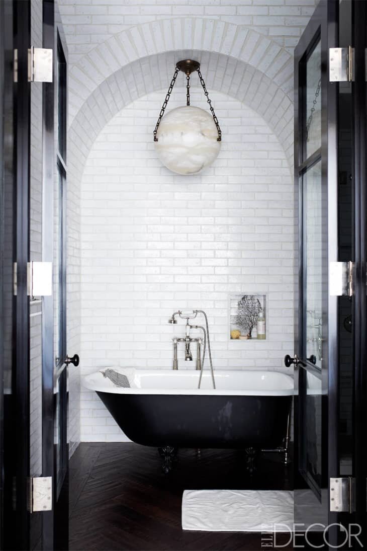 Bathroom with Geometric Enclosure and Black and White Tiling