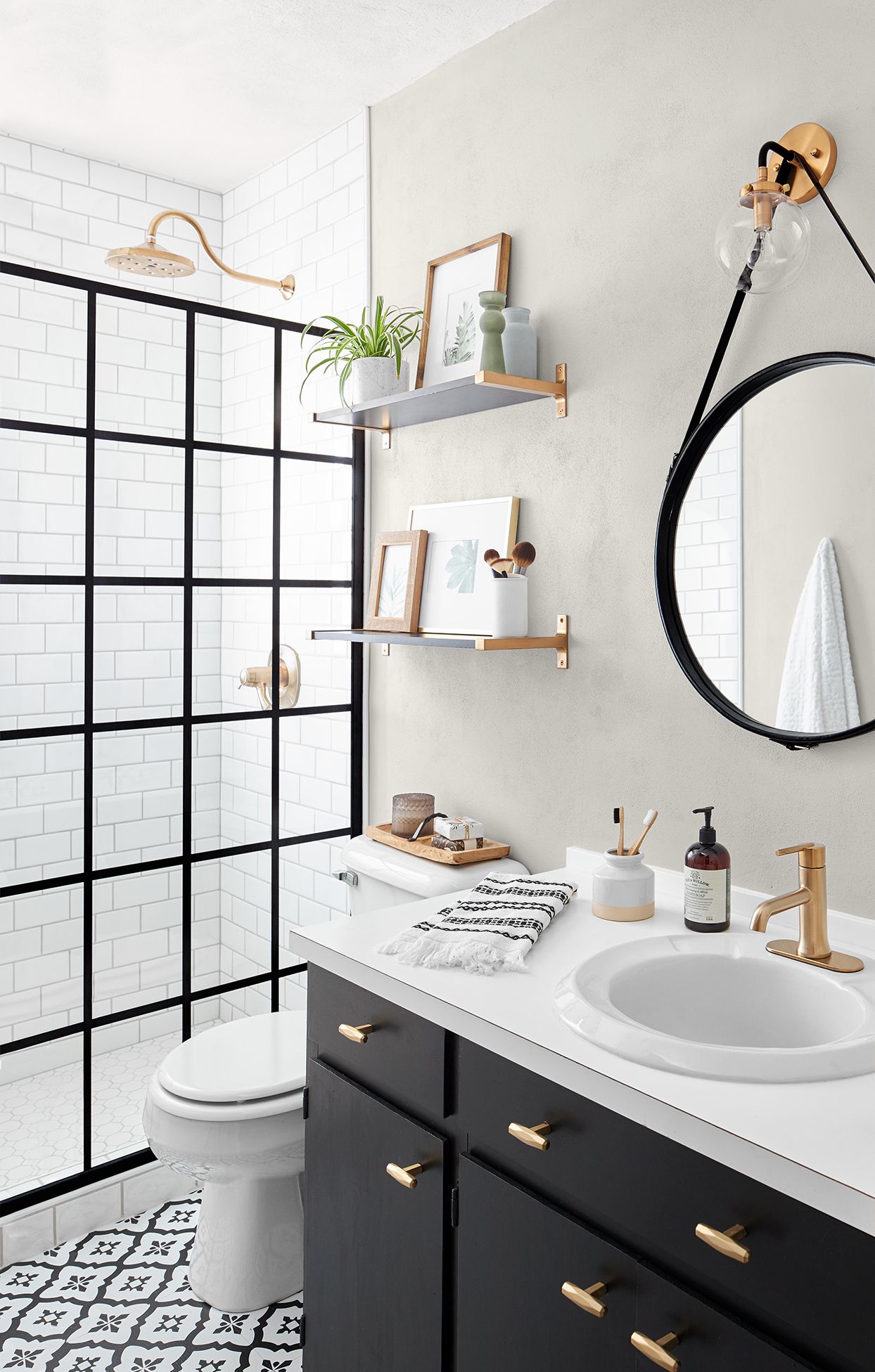 Black and White Bathroom with Curved Mirrors and Black Cabinetry