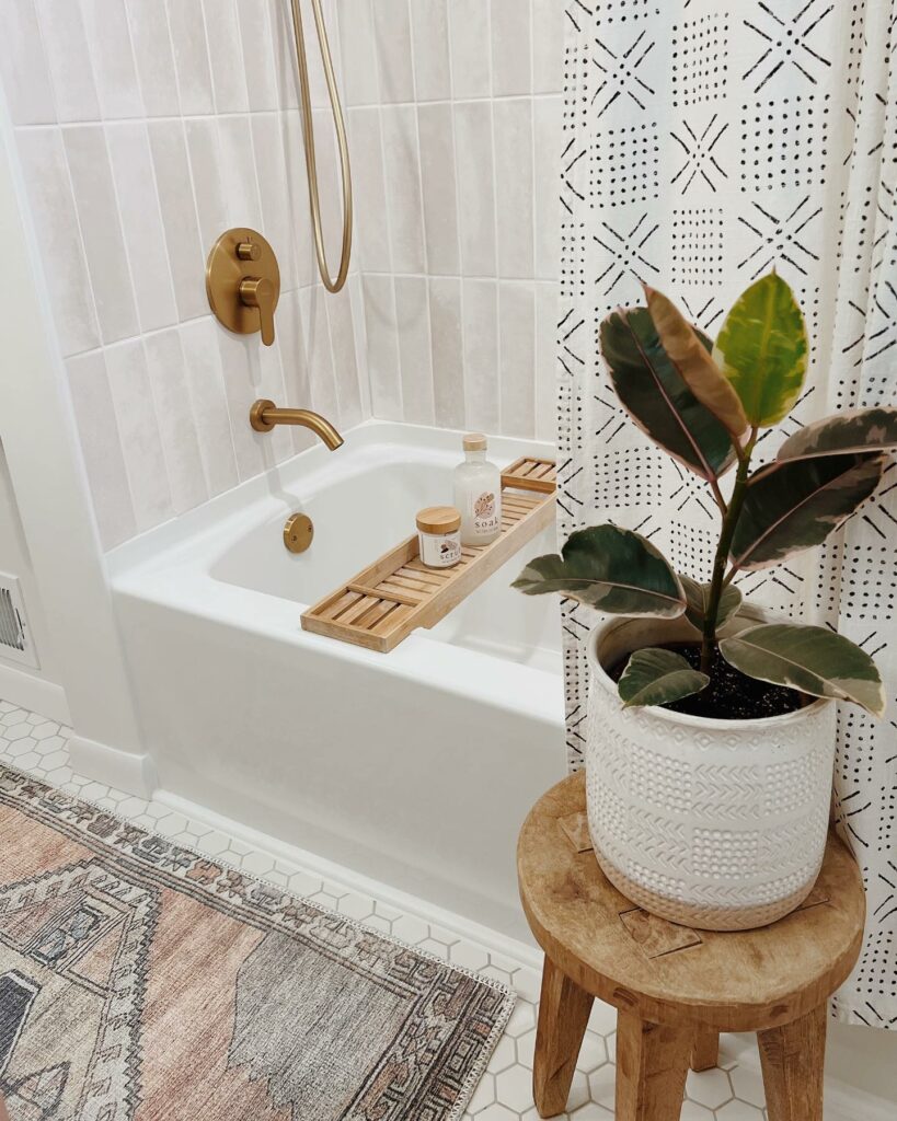 Natural boho-inspired bathroom with a freestanding tub and greenery